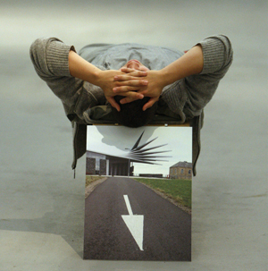 Man lying down, view from his head of him on a box